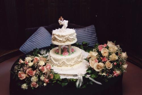 wedding cake and bouquet - this is our wedding cake with bouquet of flowers.., the motiff is pink. i love how they made our cake. it's with beads and pink flowers.
