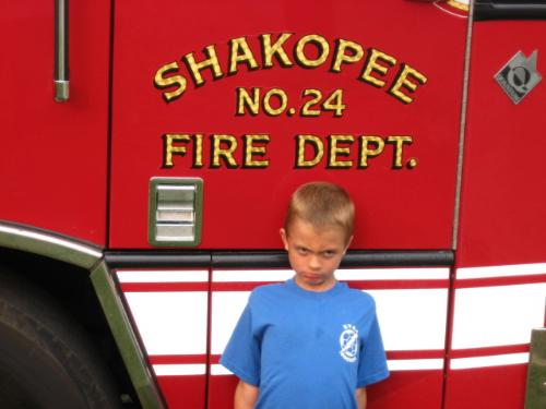 Grandson - Enjoying ythe fresh air as wll as the firetruck