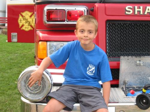 Sitting - Realxed near the siren on the front of the firetruck