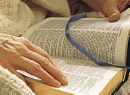 bible in hands - the Holy Bible in the hands of a reader
