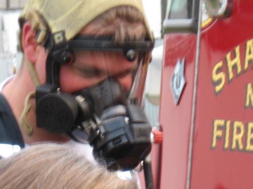 fIREMAN - dEMONSTRATING THE USE OF AN OXEGYN MASK THEY USE