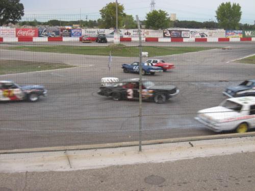 Flagpole Action - Many cars circling the flagpole at the finish line for yet another lap completed