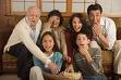 'hey, don't hog the popcorn!' - a family watching a movie together at home