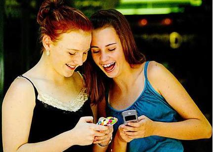 texting friends - two friends in the pic enjoy texting a lot. 