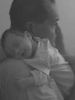 father and son - sweet picture of a father and son. Baby sleeping, father in quiet contemplation.