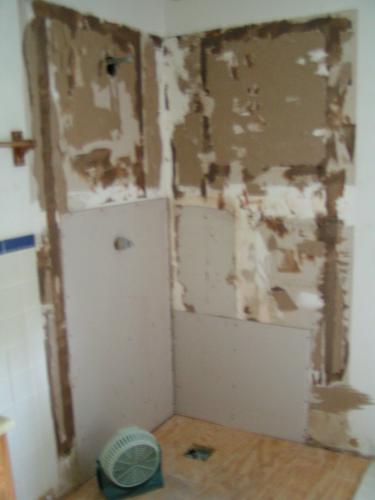 bathroom repairs - Because of a broken shower stall, I had to get my bathroom almost completely redone. This picture shows the corner where we tore out the shower and started replacing the walls.