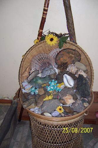 Collection of rocks and shells - This is just one of the many baskets of polished rocks, crystals and shells I have collected. Each one has special meaning to me and this large collection in a wicker stand sits by the deck doors that lead to our garden.