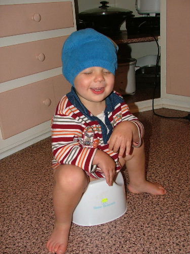 Potty training... - Here is my son, with his training pants on his head, and sitting on his potty.