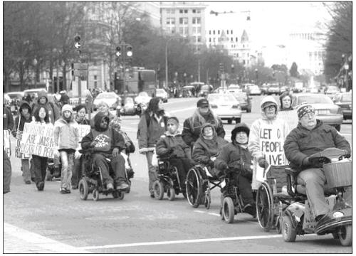 Disability rights march - This is a photograph of my friends marching at a disability rights march for homecare in DC. I might be in the picture somewhere, but I can't tell. There's nothing more inspiring than watching several hundred people with wheelchair, speech boards, and walkers or other devices marching for justice for themselves and others like them. I always cry when we're marching; happy tears, inspired tears, drivem tears, but still tears.
