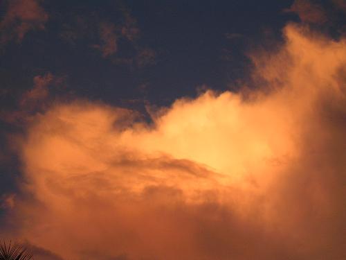 the sky - in this pic ... the clouds are seen glowing in orange.... the sun is at the backdrop .... giving the orange glow....