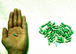 Health - A hand and medicated pills. A precover for the health section.