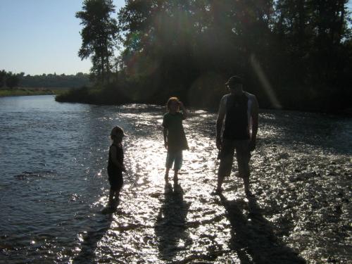 The family in the water. - We love to try and cross the river and see what is on the other side.