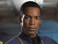 Ensign Travis Mayweather -  	 STARFLEET PERSONNEL FILE: Mayweather, Travis  Rank: Ensign Assignment: Helmsman, Enterprise NX-01 Full Name: Travis Mayweather Year of birth: 2126 Birthplace: Aboard E.C.S. Horizon, between Draylax and Vega Colony Parents: Father died in 2153; Mother is Rianna Mayweather Siblings: Brother, Paul Mayweather Weight: 72 kg Marital status: Single