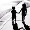 student of life - two children walking on street