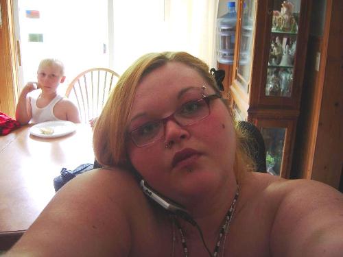 I think this is me on my cell phone! - This is yours truly, talking on my cell phone. I hate that phone sometimes! But I still look cute. Notice my nephew sitting and eating his lunch behind me!