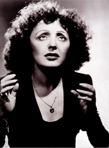 Edith Piaf - 'When one thinks of the legendary Edith Piaf, one thinks of love, music and despair. One did not breathe without the others when it came to this French singing icon. Born in Paris practically on the streets on December 19, 1915, she struggled from day one, the daughter of street performers. The mother, a singer, eventually abandoned both Edith and her father for a solo career. Piaf spent her youth entertaining passers-by, receiving little formal education in the process. She often accompanied her father's acrobat street act with her singing and at various times was forced to live with various relatives, in alleys or in cheap hotels. An aborted love affair left her with a baby girl at age 17, but little Marcelle died of meningitis at 2 years old. Devastated, Piaf returned to the streets she knew, now performing solo. Her fortunes finally changed when an impresario, Louis Leplee, mesmerized by what he heard, offered the starving but talented urchin a contract. He alone was responsible for changing her name from Edith Gassion to 'La Mome Piaf' (or 'Kid Sparrow'). Piaf began entertaining in elegant cafes and cabarets and became a singing sensation amid the chic French society with her throbbing vocals and raw, emotional power. From 1936 Piaf recorded many albums and eventually became one of the highest paid stars in the world. She was first embroiled in scandal when her mentor, Leplee, was murdered and she was held for questioning. She managed to survive the messy affair and carry on while her ever-growing society circle now began to include such elite members as writer/director Jean Cocteau. Piaf also took to writing and composing around this time; one of the over 80 songs she wrote included her signature standard, 'La vie en rose.' Piaf later toured the United States to branch out internationally. America was slow to accept the melodramatic Piaf but she persevered and eventually won legions of fans. She also continued a series of affairs with the likes of actor Paul Meurisse, composer Henry Contet and, most notably, boxing champion Marcel Cerdan. The latter's death in a 1949 plane crash left Piaf devastated and many claim this was the beginning of her downfall. Piaf had a life-long habit of involving herself heart and soul in launching the singing careers of her protegee/lovers. Over the years this would include Yves Montand, Charles Aznavour and Eddie Constantine. Two serious car accidents suffered in 1951 led to a morphine and alcohol addiction that left Piaf's life skidding out of control despite a potentially happy marriage in 1952 to actor Jacques Pills. A series of spectacular comebacks in concert and recordings would follow over the years but her health would slowly waste away. Her last appearance was at the Paris Olympia, racked with illness and barely able to stand. Her last recorded song was 'L'homme de Berlin' in 1963, the year of her death. She died in poverty on the same day as her friend Jean Cocteau and at the age of 47, the same age as her equally tortured American counterpart, Judy Garland. Piaf left many debts for her second husband (and protege) Theo Sarapo, who was twenty years younger (he died in 1970 at age 34). Piaf's funeral was massive yet, because of her lifestyle, was forbidden a Mass. It was the only time since WWII that Parisian traffic was completely stopped. A museum was dedicated in her honor. Piaf remains the epitome of the French singer in style and passion; for many Piaf IS France.'  www.imdb.com