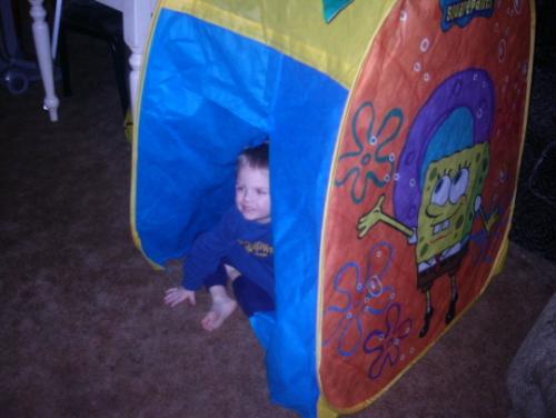 watching television - Sky in his tent..watching Sponge BOb lol..