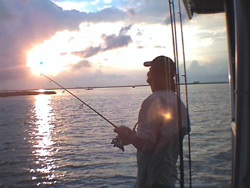 Fishing at sunrise - This is a picture of hubby. We were fishing from sunrise to sunset that day. Caught a lot of fish too. :)