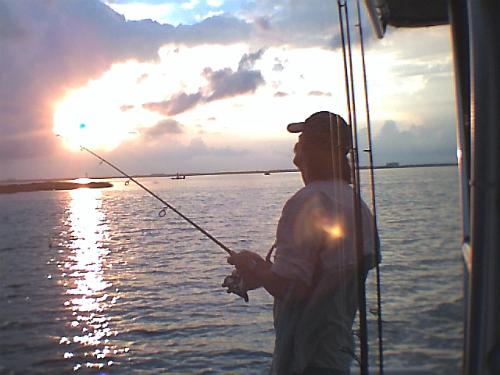 Fishing at sunrise - Here's hubby fishing at sunrise. This was a fun trip that the weather forcast didn't scare us out of. :)  Port Aransas, Texas