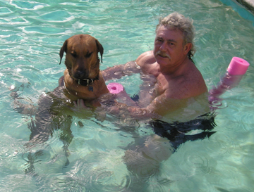 Joe and Hercules - My husband, Joe, and our dog, Hercules, swimming in the pool.  Hercules was taught to stand on his back legs on the floor of the pool so that when he got tired of swimming he didn't start panicking and trying to get out where there were no stairs.