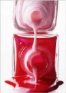 nail polish - Two nail polishes, one is pink in colour, one is red in colour.