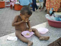 A kid along the river side - His mother get sick, He go with his sister to ask some money from people.