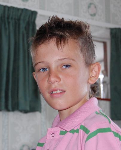 My son Bobby before his haircut - This is a picture of my 8 year old son Bobby, before my 16 year old son gave him a haircut.