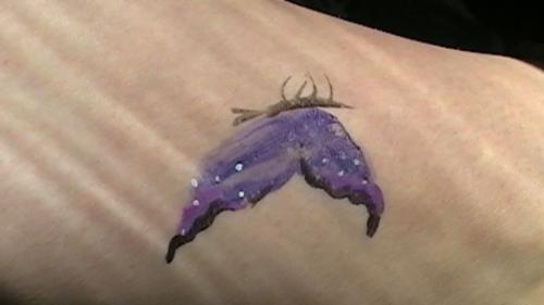 one tattoo :)  - butterfly!!  just one i loved in my fave color!!