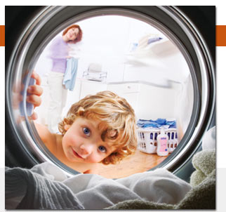 a girl and a dryer - A little girl looking into a running dryer