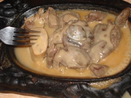 steak - What could be seen in this specific picture are several pieces of delectable steak with tasty mushroomed buttery gravy.