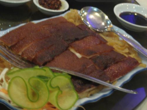 pig skin - What is evidently visible in this particular photo are several cut crunchy pig skin with sea weeds underneath it and a vegetable beside it, which basically serves as a design to make the whole dish more attractive.