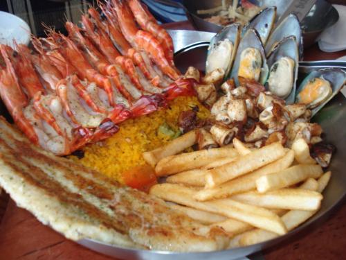 food combo - What could be seen in this specific photo is a wide variety of food from Fish & Co: prawns, fish fillet, potato fries, mussels, java rice, and squids, which are all delectable.