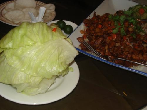 lettuce and ground duck - Fresh healthy lettuce and delicious ground duck with vegetable toppings could be seen in this specific photo.