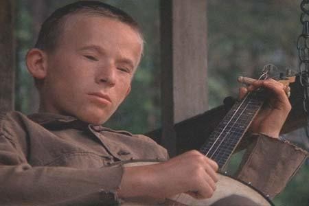 Deliverance - scene in the movie Deliverance.   Widely acclaimed as a landmark film, Deliverance is the story of four suburban professional men from Georgia on a weekend camping trip. The film is noted for the memorable music scene near the beginning that sets the tone for what lies ahead, unknown and potentially unknown. In the scene, set at a rural gas station, character Drew Ballinger plays the instrumental 'Dueling Banjos' on his guitar with a retarded hillbilly youth named Lonnie. The boy eventually outplays Drew with his banjo. The song won the 1974 Grammy Award for Best Country Instrumental Performance.
