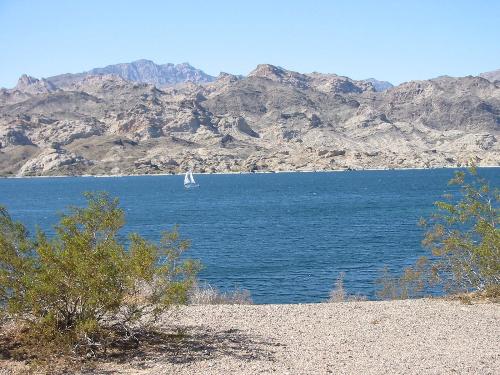 The Lake nearest us has some very narrow spots. - In this photo a lonely sail boat is gliding by.