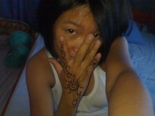 hiding myself - this picture was taken when i was in hinobaan, negros occidental. i was on my own. it was taken in my host's children's room that served as my room. it's really sad to be away with my family. i don't want that sadness to be noticed that's why i'm hiding myself... but look into my hand, i've got a very nice tattoo... i still rock!!!