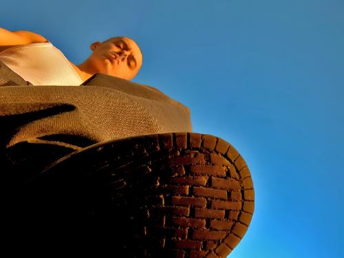 Stomping - A picture of me taken on the top of a block, sky behind me, camera looking up at me like i'm stomping on it.