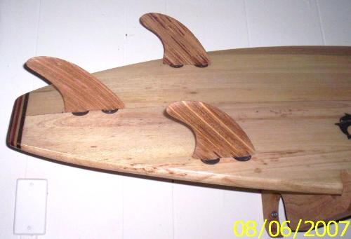 Splinter Factor Wood Designs - Wooden Surfboard accented with our custom handcrafted surfboard fins.