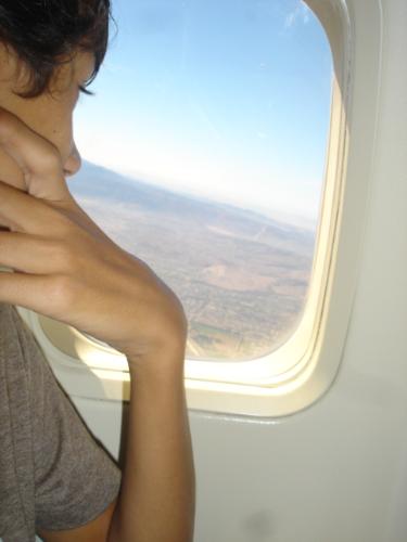 Above The Clouds - My son looking out the airplane window as we were flying over Oakland, California.