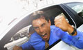 Road Rage - An angry driver exhibiting road rage.