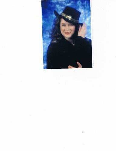 A picture of me, when I was younger, before Rosace - There was a Glamour Photo Shoot. I picked the hat and the leather coat to wear. They did my hair and make-up. They sprayed my hair so much, with hairspray, it turned dark.