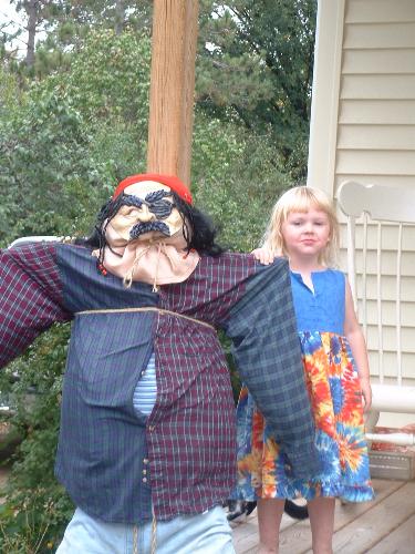 Scarecrow and Megan - Nope, not leaves, but this is Steve the Scarecrow. Megan's newest best friend. LOL!