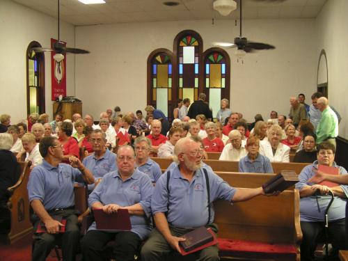 Congregation in church - Our church had a hymn sing last month which was well attended. I snapped a picture of the sanctuary as it was filling. The blue shirts are worn by members of our choir.