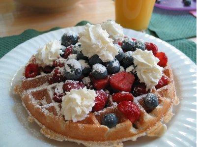 yummy waffles - this is a picture of a very yummy waffles with fruits and syrup.