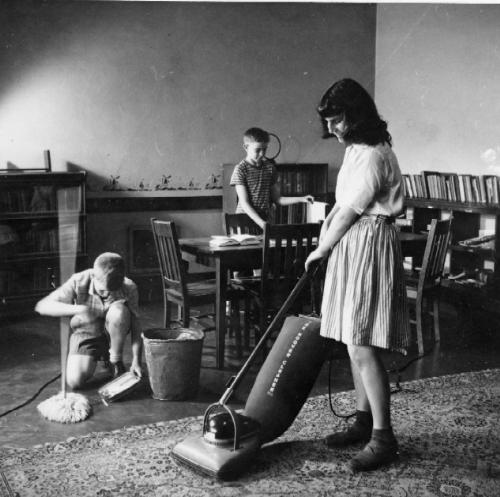 Circa.1940's - Kids Helping With Chores. - A 1940's photograph of two young sons helping their mother with the chores.