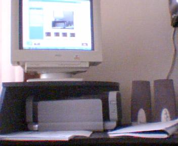 Half of my desk(picture made with my webcam) - Too bad the wire of the webcam is too short so I can't make a picture of the full desk!