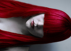 Someone with a very bright red colouring on the ha - This shows a lady who has coloured her hair with very bright red colour.