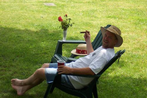 My husband relaxing in our yard. - My husband relaxing in our yard.