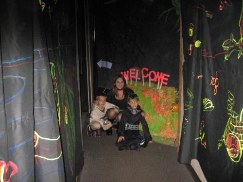 daughter,grandsons - At the entrance to the Halloween black light room at a local nature center festival.