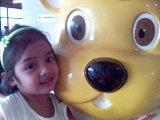 my niece - my cute niece w/ bear statue